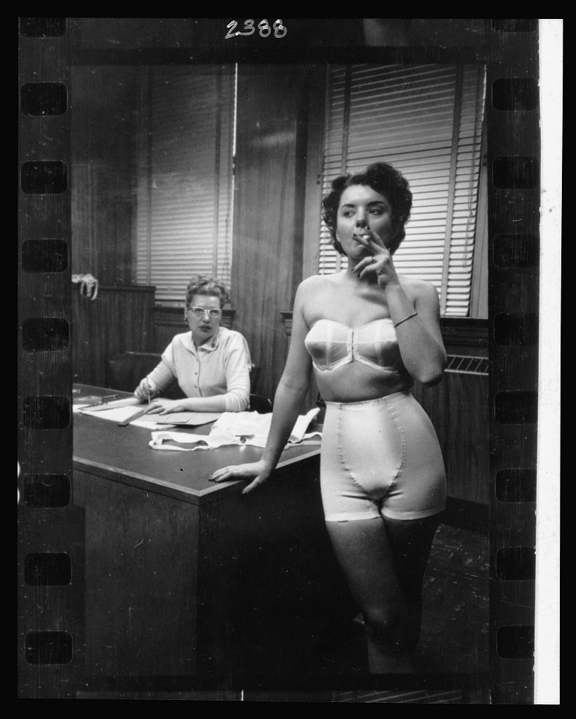 Lingerie model smoking in an office, © Stanley Kubrick, 1949